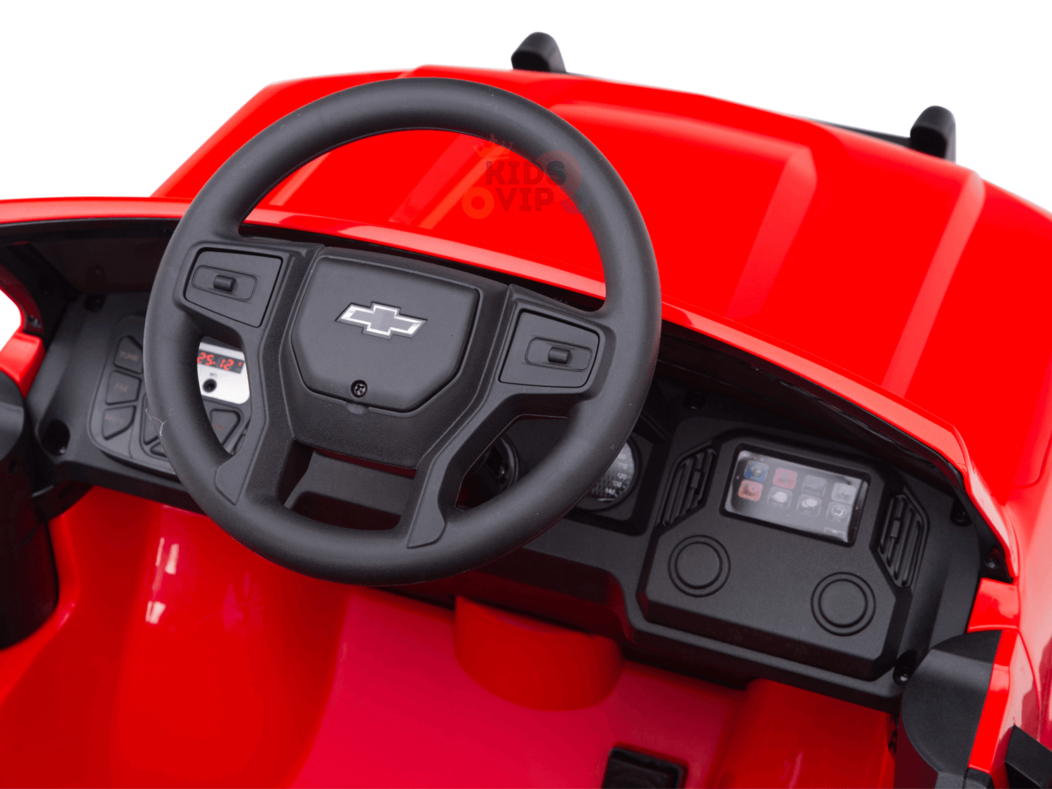 Interior view of a red toy car with a Chevrolet logo on the steering wheel and simple dashboard. The Red 24V Chevrolet Silverado Kids Licensed Ride-On Truck features a glossy finish and oversized wheels, perfect for mini adventures.
