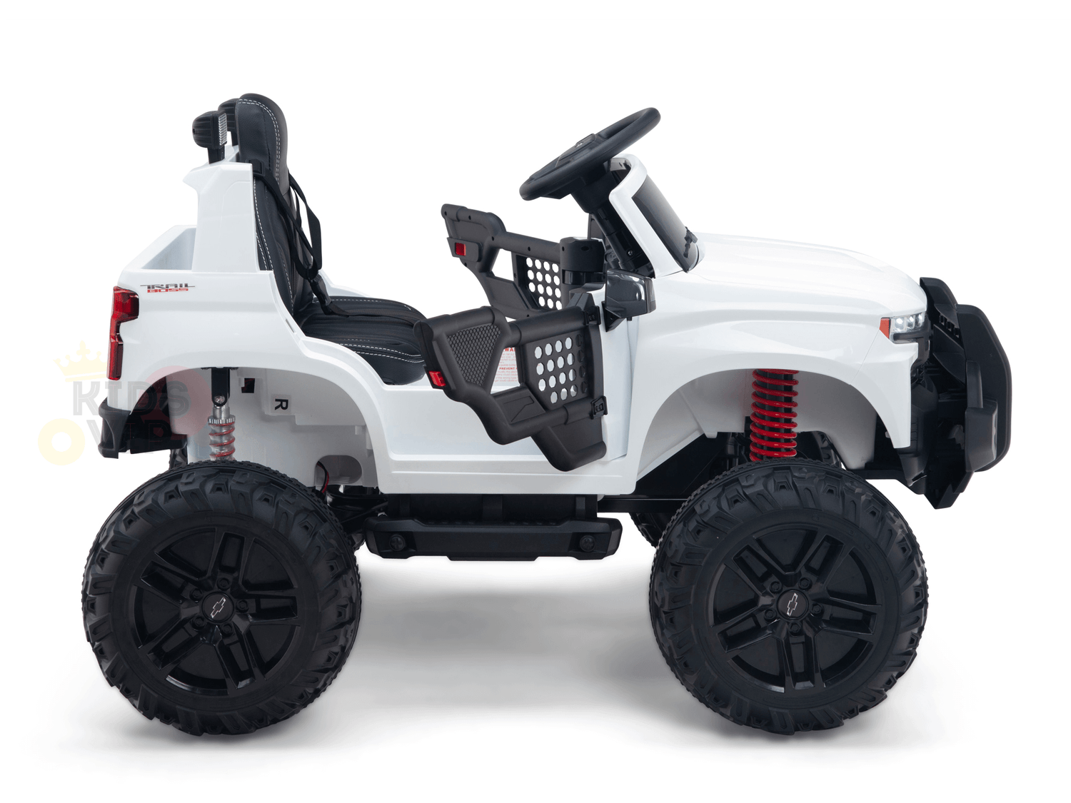 Side view of the White 24V Chevrolet Silverado Kids Licensed 1 Seater Ride On Lifted Truck, featuring oversized black tires, red suspension springs, open sides, a steering wheel, and rugged off-road charm perfect for adventurous young drivers.