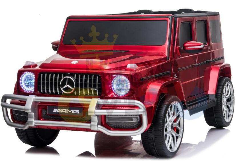 The 2 Seats 4x4 Official Mercedes Benz G63 Complete Edition Red 24V Kids Ride On Car includes a luxury SUV design with glossy finish, prominent grille, detailed bumpers, realistic headlights, chrome accents, AMG branding, and a gold crown logo overlay.
