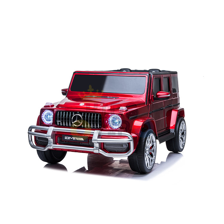 The 2 Seats 4x4 Official Mercedes Benz G63 Complete Edition Red 24V Kids Ride On Car with RC mirrors the luxury of a real G63, featuring chrome details, large wheels, glowing headlights, a detailed front grille, and the brand emblem for an authentic ride.