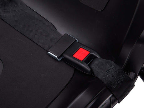 Close-up of a black car seat with a safety belt fastened into a buckle, featuring a prominent red release button similar to controls in the Big Kids Powerful 24V Speedster Drifting Go-Kart. Shadows emphasize the smooth texture reminiscent of high-speed karting adventures.