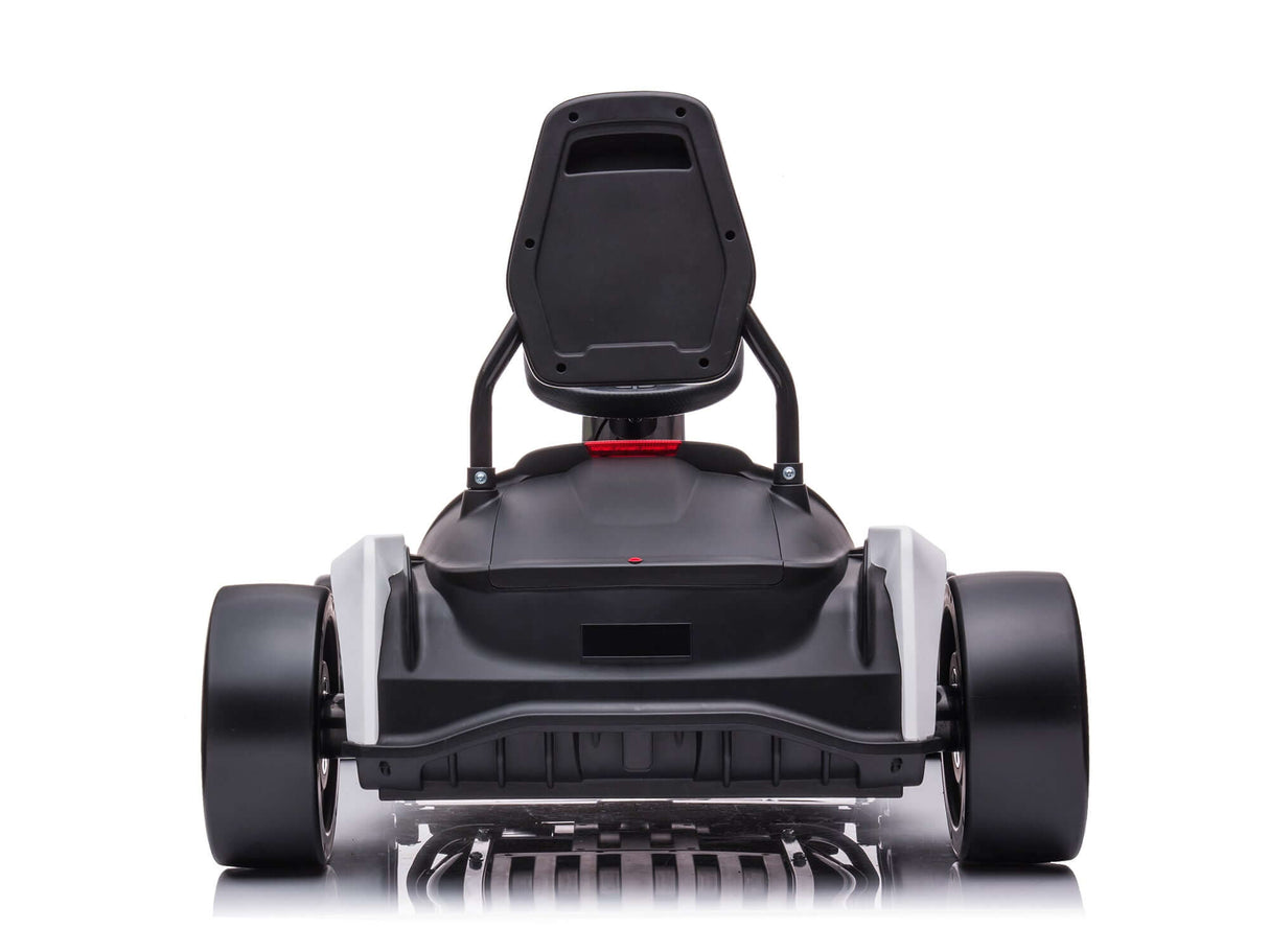 The Big Kids Powerful 24V Speedster Drifting Go-Kart showcases a sleek, black design with aerodynamic features, including a contoured seat, large tires, and a minimalistic frame. Positioned on a reflective surface, it highlights its modern appearance as the ultimate go-kart for big kids.