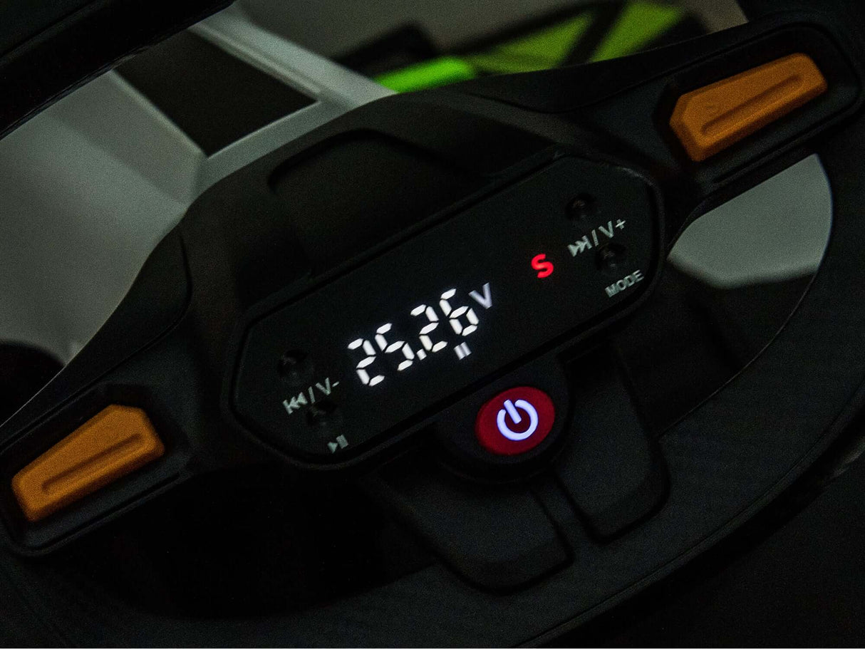 A close-up of a steering wheels digital display shows 26.28 among symbols and buttons, including a striking red power button. The black surface with orange accents hints at the thrill of the Big Kids Powerful 24V Speedster Drifting Go-Kart, ideal for upscaled adventures.