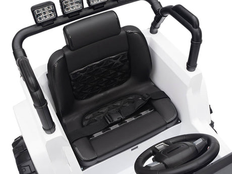 The White 12V Sport Edition Trailcat Big Wheels Kids Ride on Truck with RC features a black seat with harness, steering wheel, and toy car dashboard. Its quilted padding enhances comfort, while the rugged bars and lights accent the exterior for adventure-filled play.