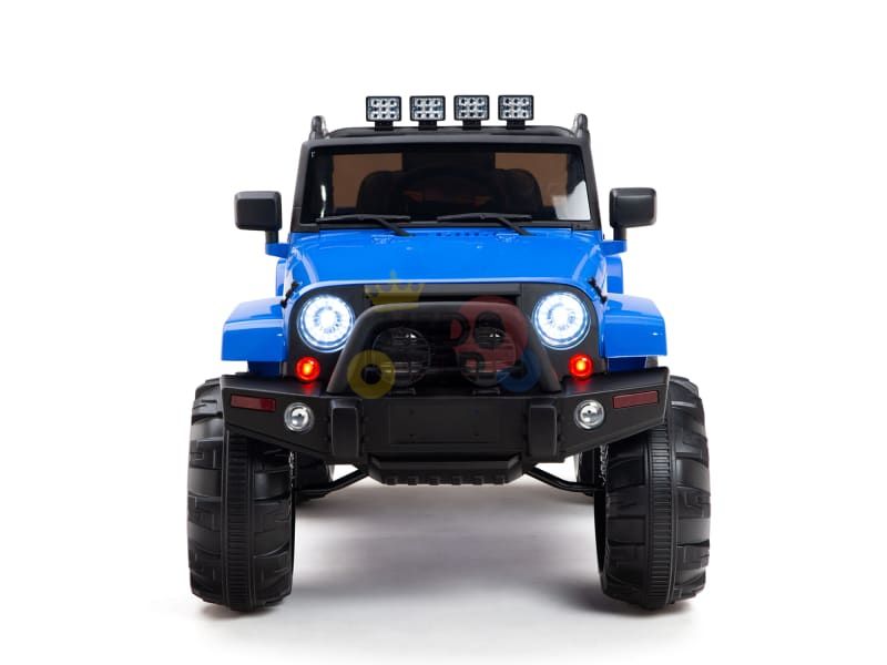 A front view of the Blue 12V Sport Edition Trailcat Big Wheels Kids Ride on Truck with RC shows its large black wheels, illuminated headlights, and roof lights. The rugged design is displayed on a white background, perfect for childrens outdoor adventures.