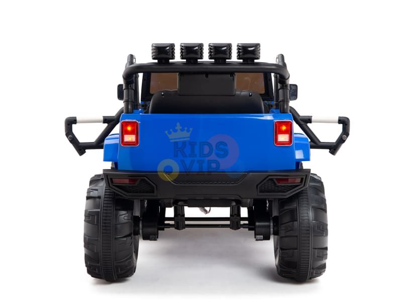 The rear view of the Blue 12V Sport Edition Trailcat Kids Ride-on Truck showcases its SUV-like design, featuring big wheels, a roll bar with lights, and a spare tire. This vehicle combines style with adventure for an exciting kids ride.