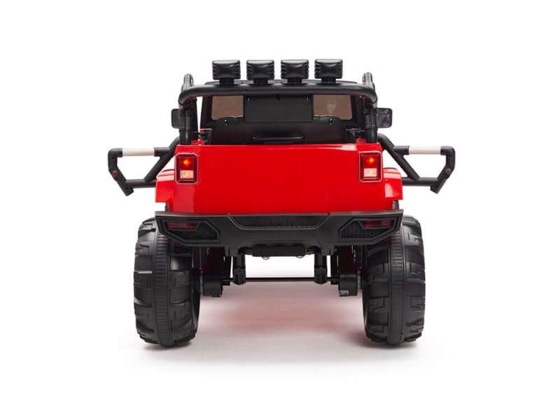 Rear view of a Red 12V Sport Edition Trailcat Big Wheels Kids Ride on Truck with RC, featuring oversized wheels, large black tires, side mirrors, top row spotlights, and visible suspension details against a white background.
