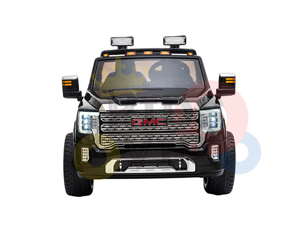 Front view of the Black 2x12V Licensed 4WD GMC Sierra Kids Ride On Car with RC, showcasing realistic headlights, grille, side mirrors, roof lights, and a short mounted aerial against a neutral background.