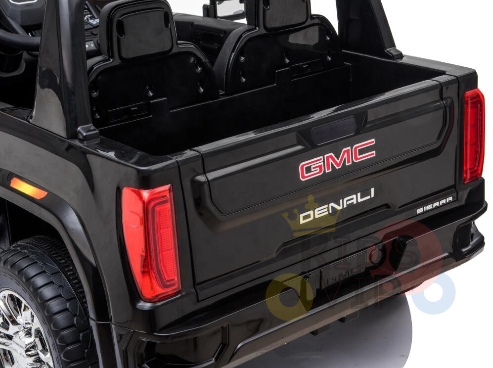 The Black 2x12V Licensed 4WD GMC Sierra Kids Ride On Car features detailed red taillights and a visible logo on the tailgate, set against a white background.
