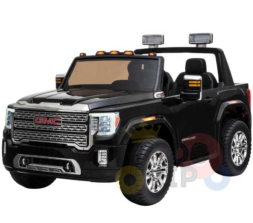 The Black 2x12V Licensed 4WD GMC Sierra Kids Ride On Car boasts a detailed grille, headlights, side mirrors, and large wheels. Featuring two seats under roll bar lights with the logo front and sides, it includes a parental remote for added safety.