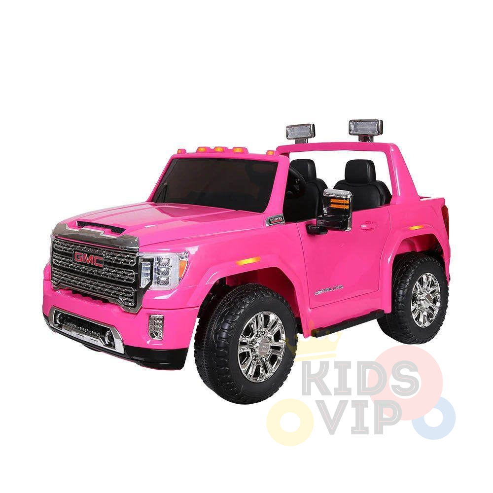 The Pink 2x12V Licensed 4WD GMC Sierra Kids Ride On Car with RC features chrome accents, black seats, mounted lights, and large wheels for realism. The KIDS VIP logo is displayed in the bottom right corner, offering a stylish adventure for young drivers.