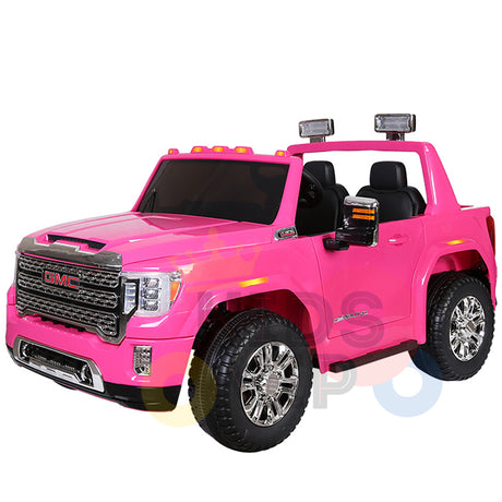 The Pink 2x12V Licensed 4WD GMC Sierra Kids Ride On Car with RC features chrome details, realistic headlights, black seats, rugged wheels, and side mirrors for a lifelike driving adventure.