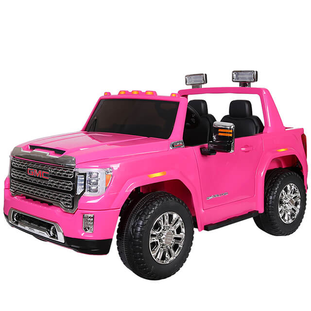 This vibrant pink 12V GMC Sierra ride-on truck glistens with chrome details and sturdy black tires. With two seats, side mirrors, top-mounted lights, an open roof, and a detailed front grille, its crafted for childrens adventures and promises endless fun.