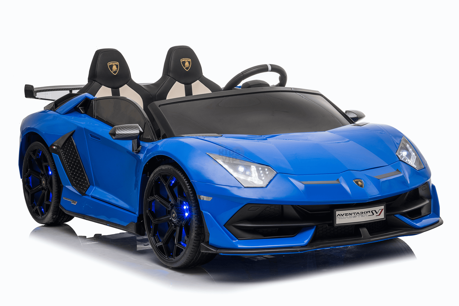 A blue 24V Lamborghini SVJ ride-on car, designed like a futuristic sports car, features two black seats, angular headlights, and a sleek design. It includes parental remote control for safety, blue-lit wheels, and the front license plate reads Aventador SV.