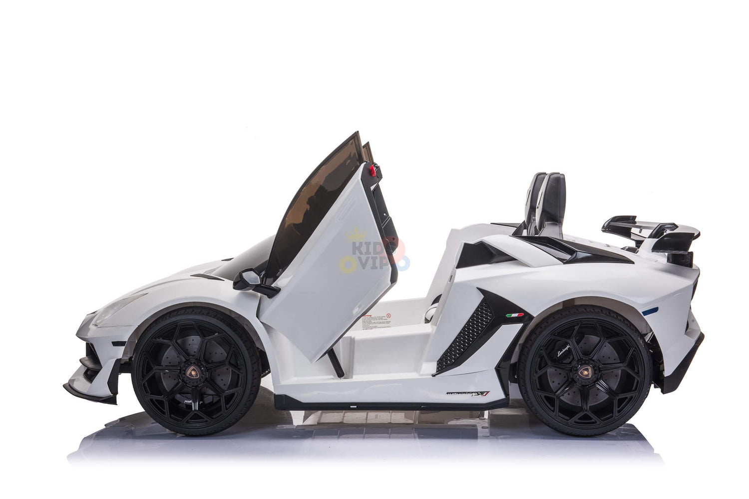 Side view of the White 24v Lamborghini SVJ Drifting Kids Ride on Car features scissor doors, black wheels, and a racing seat. The Kids VIP logo is on the doors as it stands ready for action on a glossy white surface with specialized drifting wheels.
