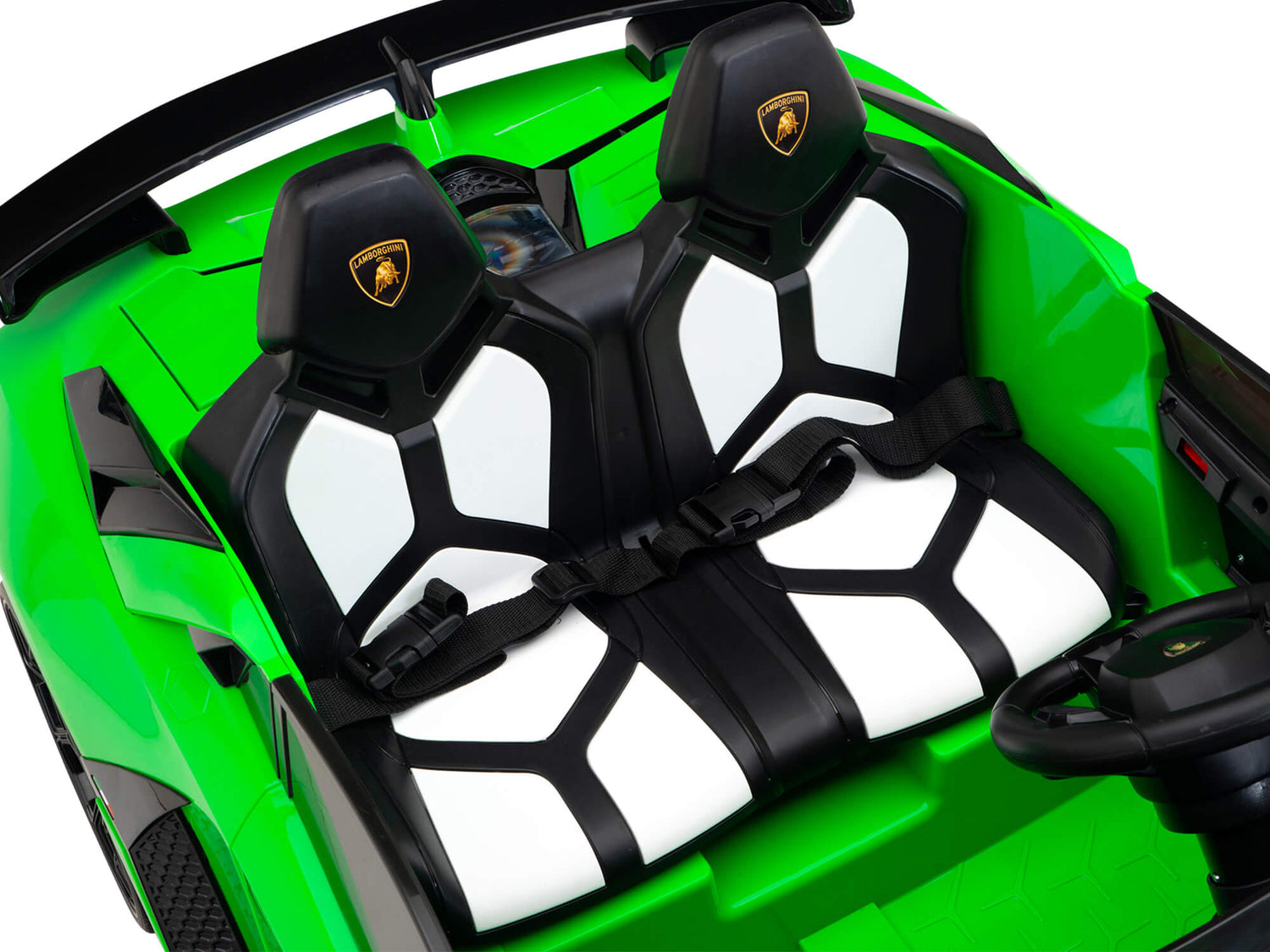 Close-up of the Upgrade Your Ride with the Official 24v Lamborghini SVJ Drifting Kids Ride on Car interior: black and white seats with harnesses, a black steering wheel, a bright green exterior, dual HP motors for extra power, and headrests featuring a triangular emblem.
