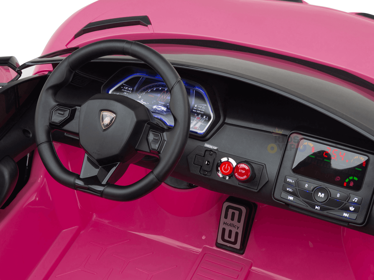The image shows the interior of the Upgrade Your Ride with the Pink 24v Lamborghini SVJ Drifting Kids Ride on Car, featuring a black steering wheel, digital dashboard with blue lighting, control panel with buttons and display screen, and Holly branded pedal area for an exhilarating experience.