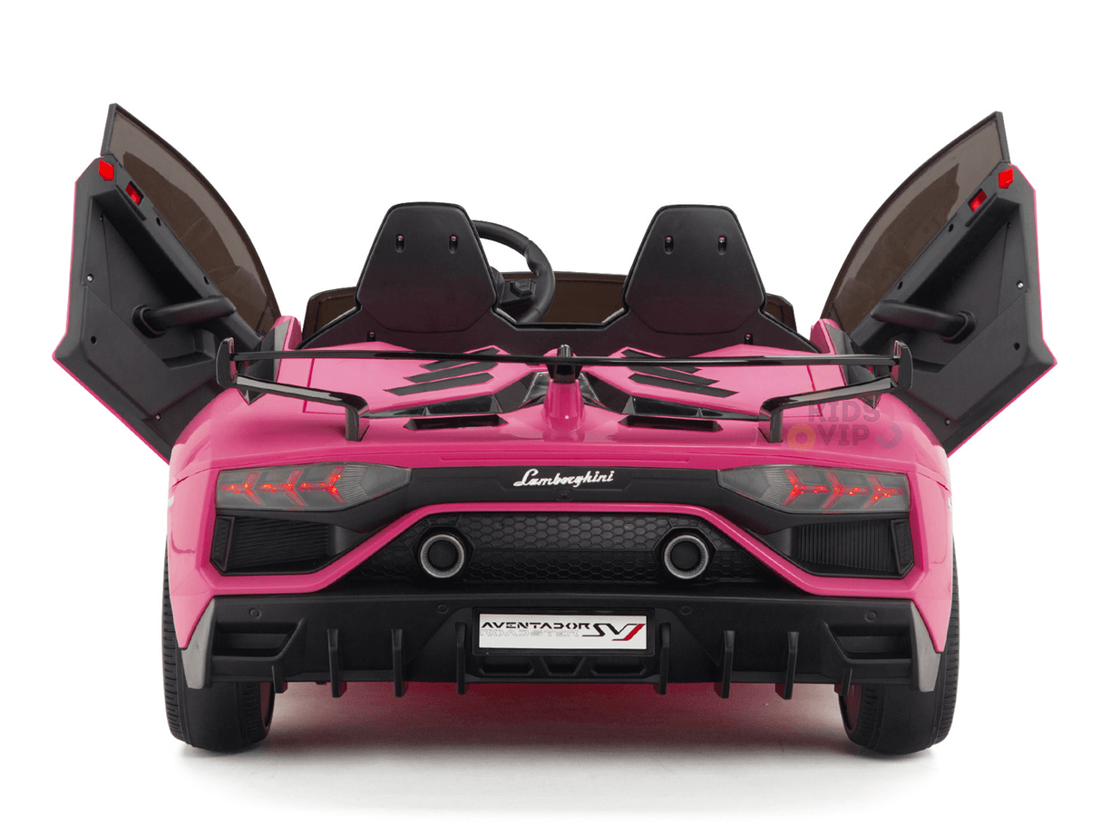 The Upgrade Your Ride with the Pink 24v Lamborghini SVJ Drifting Kids Ride on Car features open scissor doors, a detailed rear design with a black bumper, red taillights, and the iconic logo. The license plate reads AVENTADOR SV, perfect for thrilling adventures.