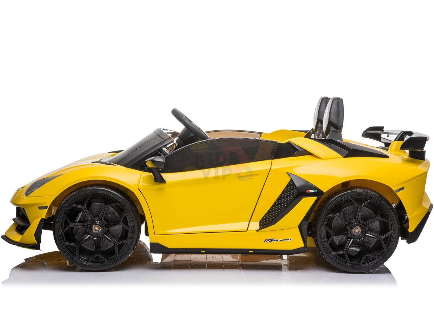 This yellow 24v Lamborghini SVJ ride-on car for kids has black details, an aerodynamic open-top design, two seats, a rear spoiler, and prominent drifting wheels for an authentic race feel.