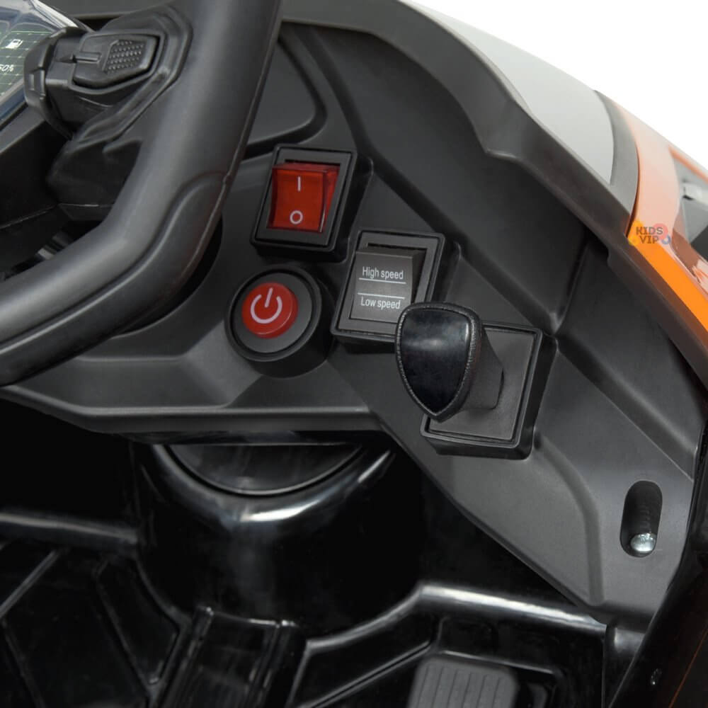 The Orange 12V Official Lamborghini Vision GT Kids Ride-On Car features a dashboard with a steering wheel, power button, High Speed and Low Speed switches, enhanced by black and grey surfaces with an orange accent. A 12V battery powers the thrilling ride.
