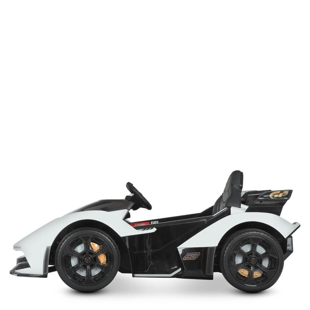 The White 12V Official Lamborghini Vision GT Kids Ride-On Car features a sleek black and white sporty design with a low profile, aerodynamic curves, steering wheel, black seats, gold-accented wheels, and racing-style decals.