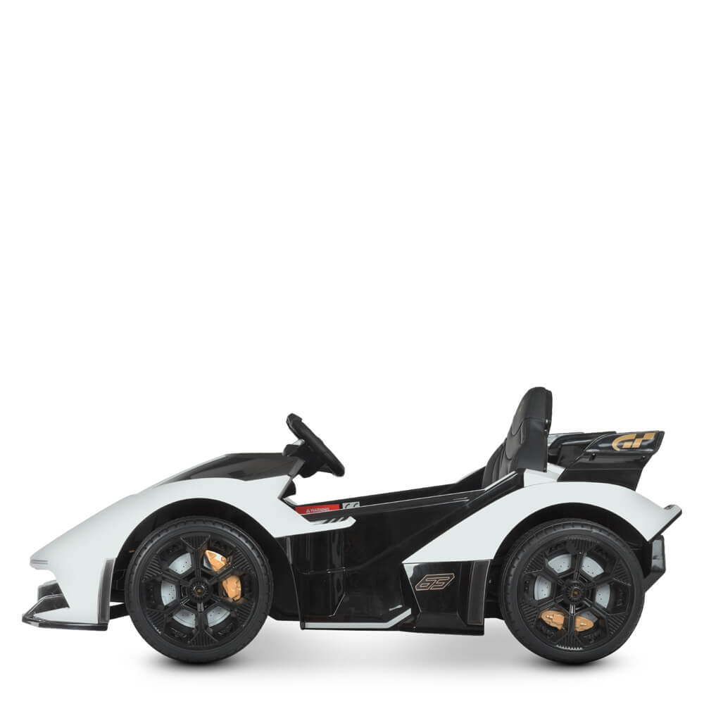 The White 12V Official Lamborghini Vision GT Kids Ride-On Car features a sleek design with black and gold accents, large wheels, and a low profile. Displayed in a left-profile view on a white background, this toy sports car mimics the iconic Lamborghini Vision GT.