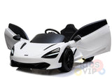 A white 12V McLaren 720S Kids Licensed Ride On Car, complete with scissor doors, sleek black accents, an upgraded steering wheel, and rubber wheels, is displayed on a smooth reflective surface.