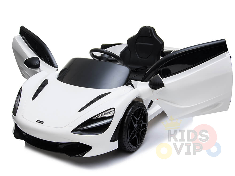The image showcases a White 12V McLaren 720S Kids Licensed 1 Seater Ride On Car featuring sleek scissor doors, a black interior, detailed headlights, and rubber wheels. It includes a remote control for convenience and displays the Kids VIP logo in the corner.