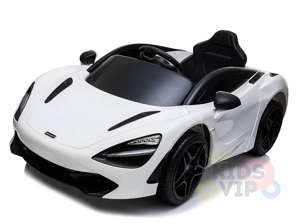 The White 12V McLaren 720S Kids Licensed Ride On Car, featuring rubber wheels and a remote, showcases sleek aerodynamic curves with black accents. It includes detailed headlights, a single seat, and steering wheel, boasting partial Kids VIP branding on the bottom right.