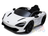 The White 12V McLaren 720S Kids Licensed Ride On Car, featuring rubber wheels and a remote, showcases sleek aerodynamic curves with black accents. It includes detailed headlights, a single seat, and steering wheel, boasting partial Kids VIP branding on the bottom right.