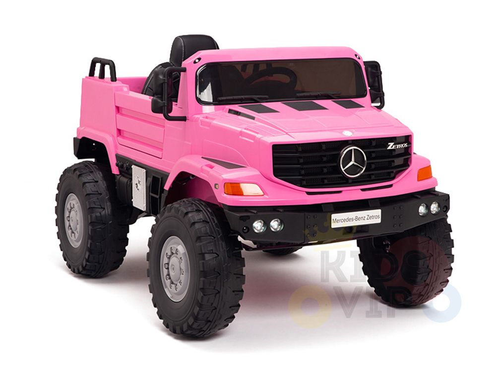 The Pink 12V Mercedes Benz Zetros Kids Ride-On Truck features rubber wheels, a detailed grille, side mirrors, and a black interior. Powered by a 12V12amp battery, its perfect for young adventurers.