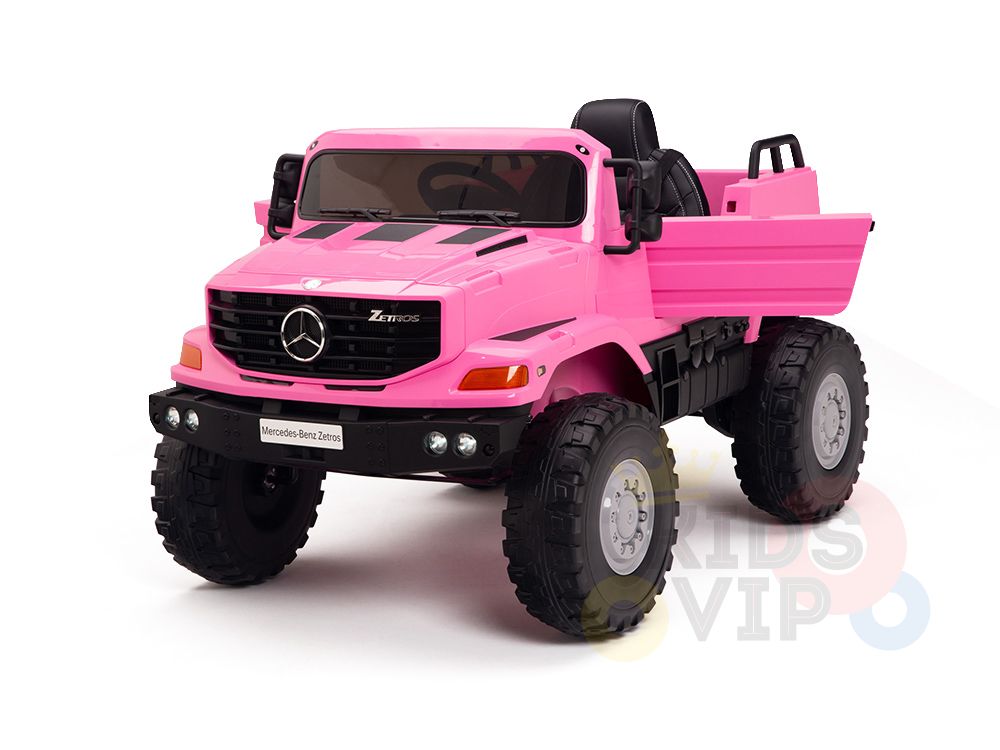 The Pink 12V Mercedes Benz Zetros Kids 1 Seater Ride On Truck features rubber wheels, open seating, and resembles a real Zetros with its emblem and grille. Ideal for outdoor adventures, it has a visible cargo area and includes a remote control for added fun.