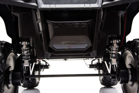 Low-angle shot of the Black Official 12V Mercedes Unimog Junior 4X4 Kids Ride On UTV with Remote Control, highlighting its strong suspension and durable tires. The neutral background accentuates the intricate mechanical details and powerful 12V battery.