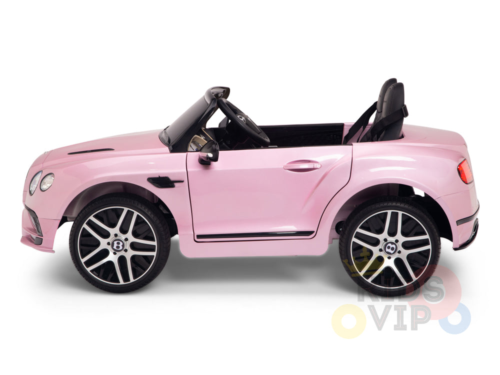 The Pink 12V Bentley GTC Kids Licensed Ride On Car features rubber wheels, a black interior, and realistic design elements. It includes a parental remote control for extra fun, capturing the sporty vibe of a luxury convertible.
