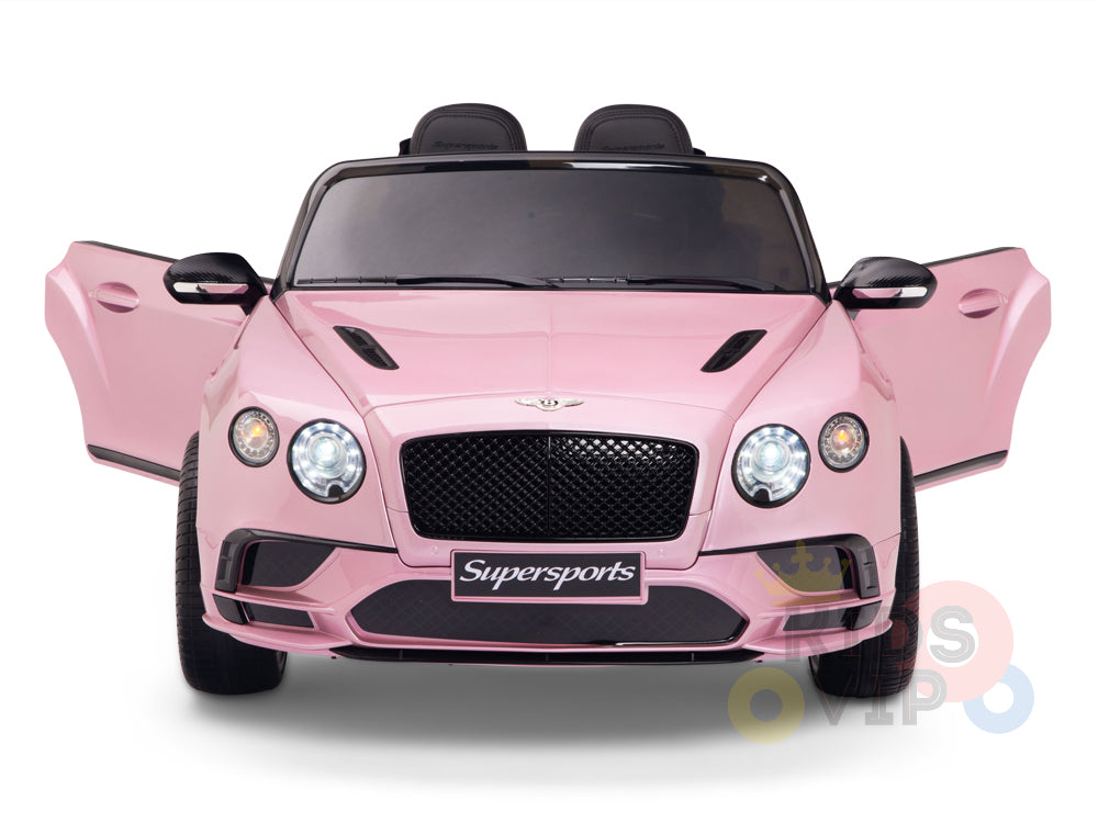 The Pink 12V Bentley GTC Kids Licensed Ride On Car features open gullwing doors, sleek black detailing, Supersports on the grille, and glowing headlights. Positioned against a white background, its perfect for little drivers with optional parental remote control.