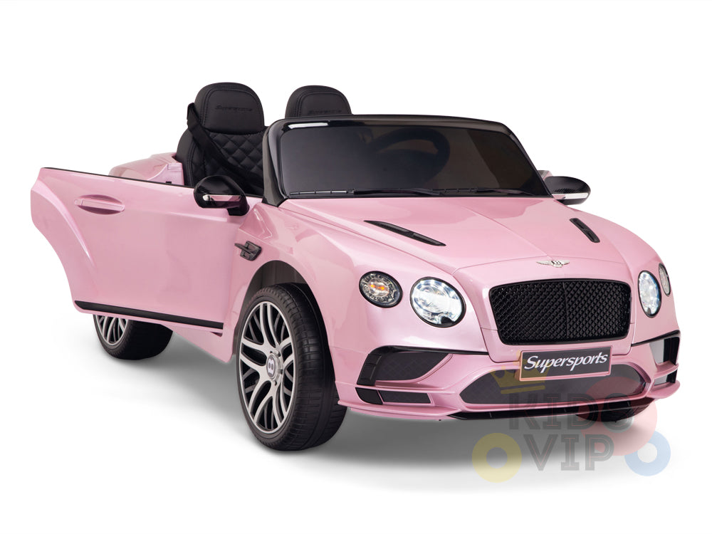 The Pink 12V Bentley GTC Kids Licensed Ride-On Car features black seats, realistic headlights, alloy-style wheels, one open door, and visible branding. It includes a parental remote for safety and rubber wheels for a smooth ride.