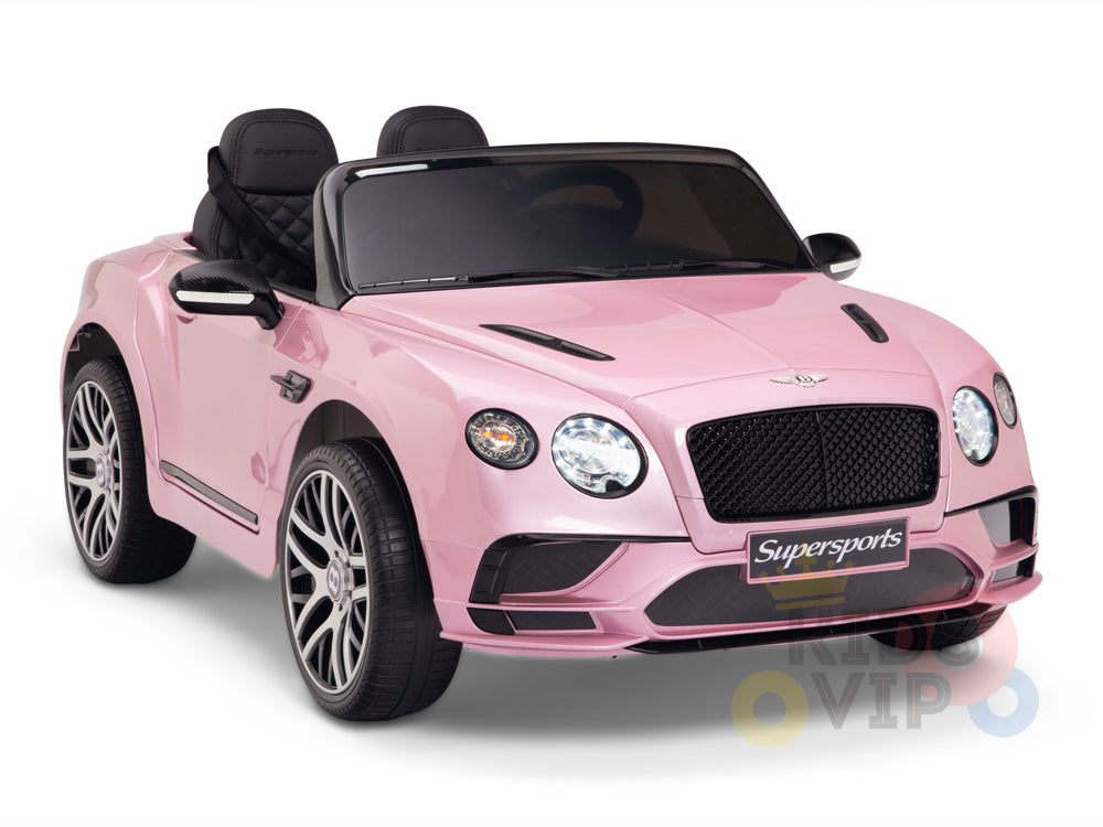 The Pink 12V Bentley GTC Kids Licensed Ride-On Car features black seats, a detailed front grille, round headlights, silver wheels with intricate spokes, a Supersports front plate, and includes a parental remote control for added safety.