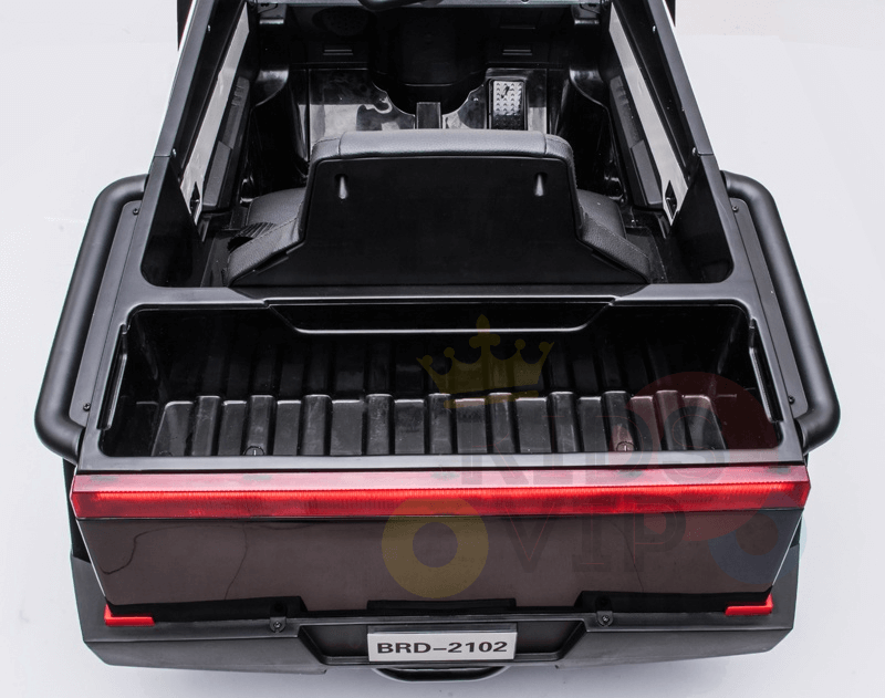 The open bed of the Futuristic 12V Police Truck Ride On, featuring a red light and license plate BRD-2102, offers a sleek design reminiscent of futuristic series, with black bodywork and visible ridges enhancing its utilitarian elegance like emergency vehicles.