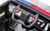 A close-up of the toy police trucks dashboard and steering wheel from the Futuristic 12V Police Truck Ride On, featuring red buttons, dials, and controls. Police lights on the roof highlight its role among emergency vehicles for kids and toddlers.