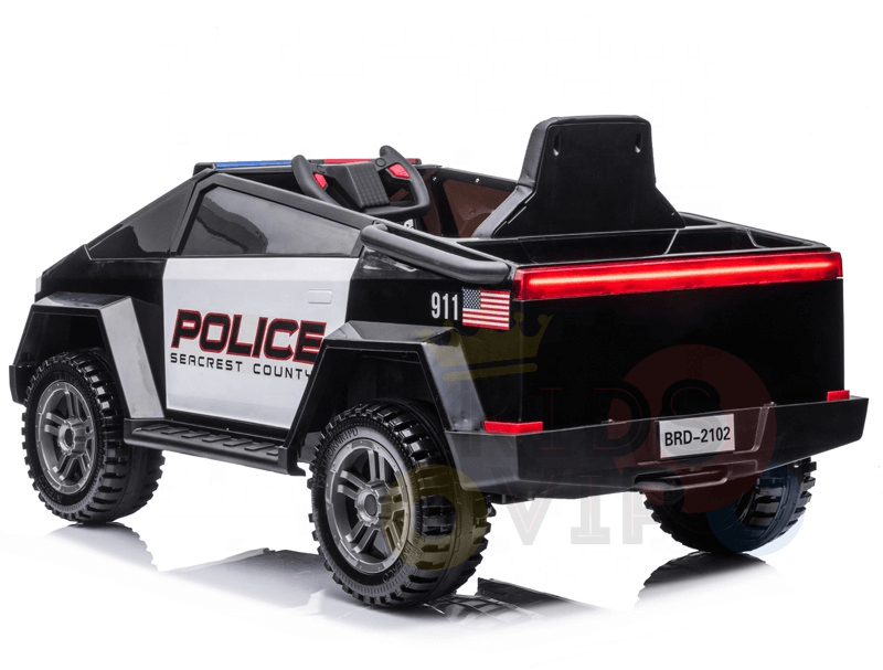The Futuristic 12V Police Truck Ride-On for Kids and Toddlers resembles an emergency vehicle with Police and Seacrest County markings, large rugged tires, a sleek black-and-white design, a U.S. flag, the number 911, and model number BRD-2102 on the back.