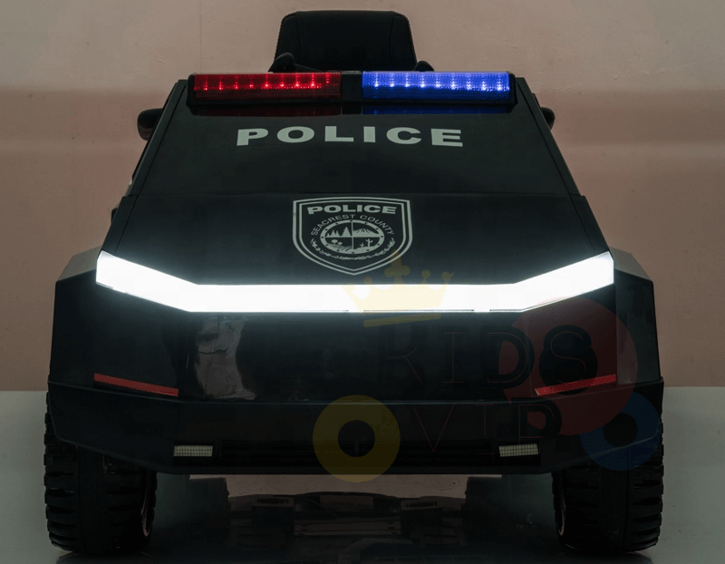 The Futuristic 12V Police Truck Ride On for Kids and Toddlers, part of the Futuristic Series, features POLICE on the windshield. Its sleek design is enhanced by red and blue roof lights and a striking front shield emblem.