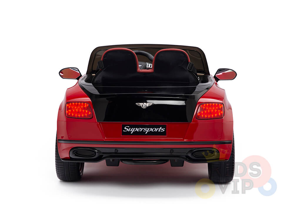 The rear view of a red and black Red 12V Bentley GTC Kids Licensed Ride On Car, featuring Supersports on the back, showcases red taillights, dual exhausts, and two black seats. This electric toy is set against a white background.
