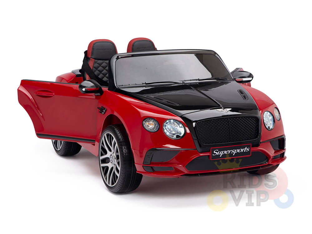 The Red 12V Bentley GTC Kids Licensed Ride On Car with Rubber Wheels and Remote resembles a luxury convertible, featuring realistic headlights, a detailed grille, two seats, the drivers door open, visible wheels, and the Supersports logo on front for an authentic experience.