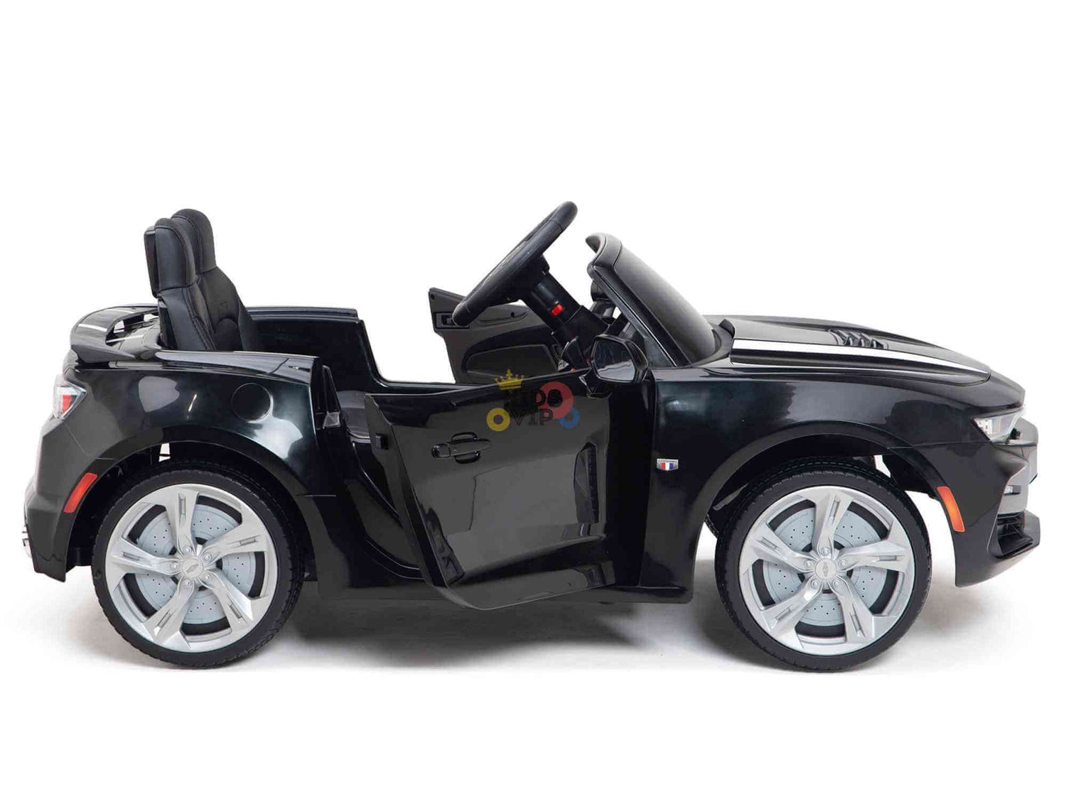The Black Official Sport 12V Chevrolet Camaro Kids Ride-on Car boasts sleek silver Eva rubber wheels, a luxurious black interior with ECO leather seat, and an open drivers door, letting young drivers imagine the thrill of this sporty roadster.