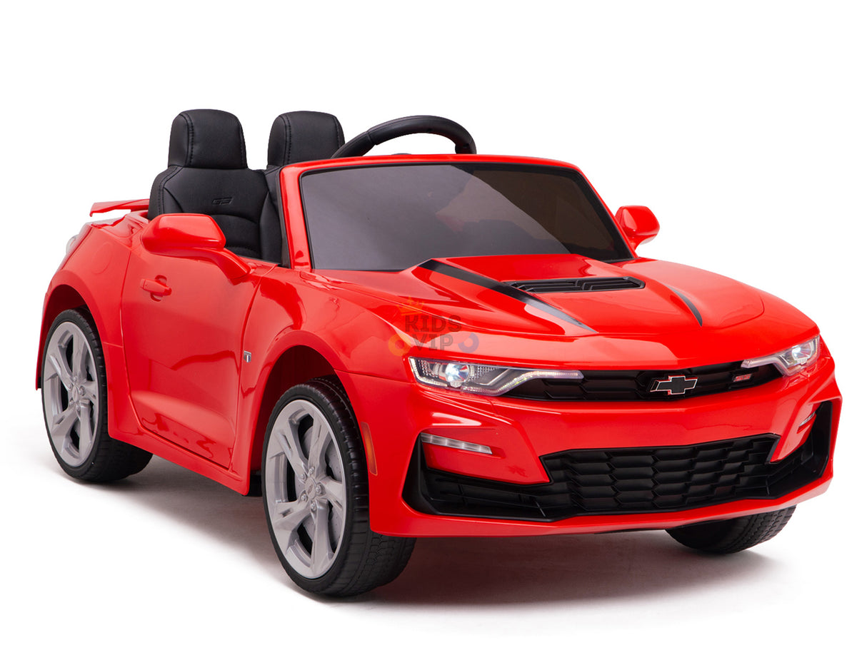 The Red 12V Official Sport Chevrolet Camaro Kids and Toddlers Ride on Car includes a 12V battery, two black seats, a small steering wheel, silver wheels, and remote control for parental oversight. It mirrors the iconic design, making it perfect for young drivers.