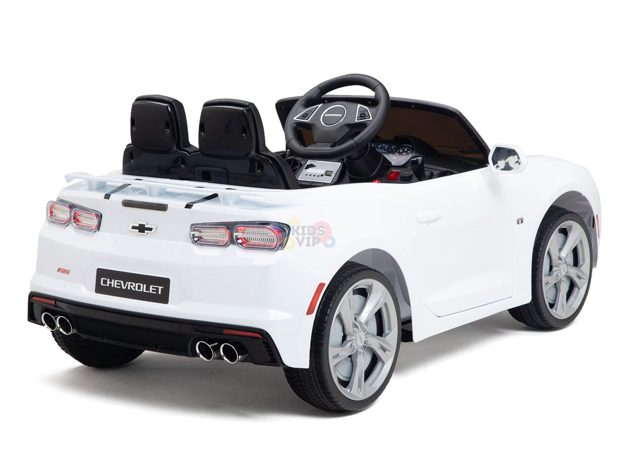 The White 12V Official Sport Chevrolet Camaro Kids and Toddlers Ride on Car features black seats, dual exhaust pipes, a control-equipped dashboard, a distinct rear emblem, and a visible steering wheel—ideal for little drivers ready for their adventure.