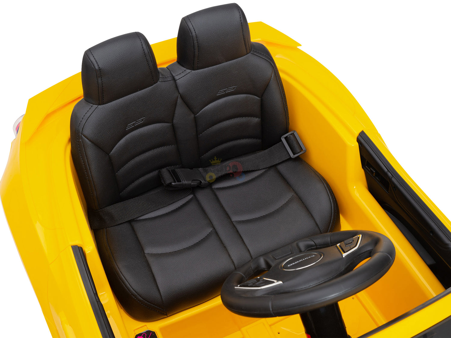 The Yellow 12V Official Sport Chevrolet Camaro ride-on toy car features an interior with two black leather seats, seat belts, a black steering wheel, and simple dashboard controls. Parents can easily control the car using the intuitive remote, making it ideal for kids and toddlers.