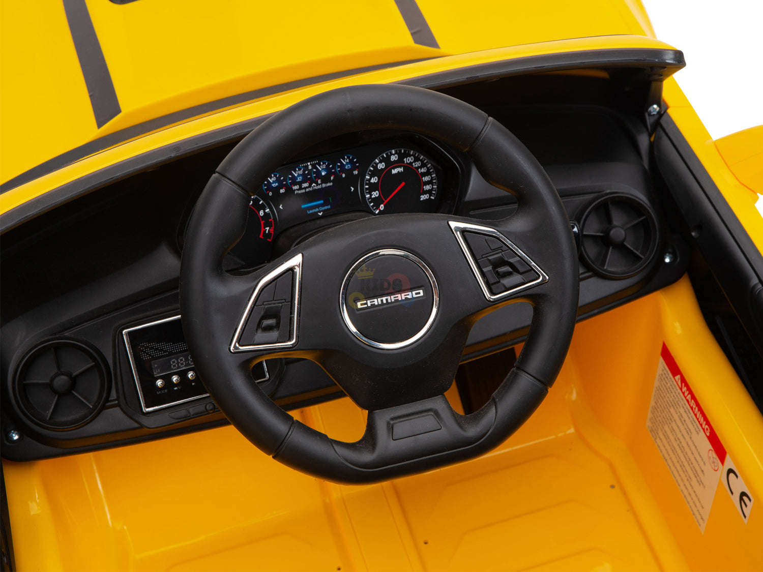 Close-up of the steering wheel and dashboard on a Yellow 12V Official Sport Chevrolet Camaro Kids and Toddlers Ride on Car, featuring detailed gauges, controls, and the iconic Camaro logo. Designed for young drivers, it includes an optional parental remote control for added safety.