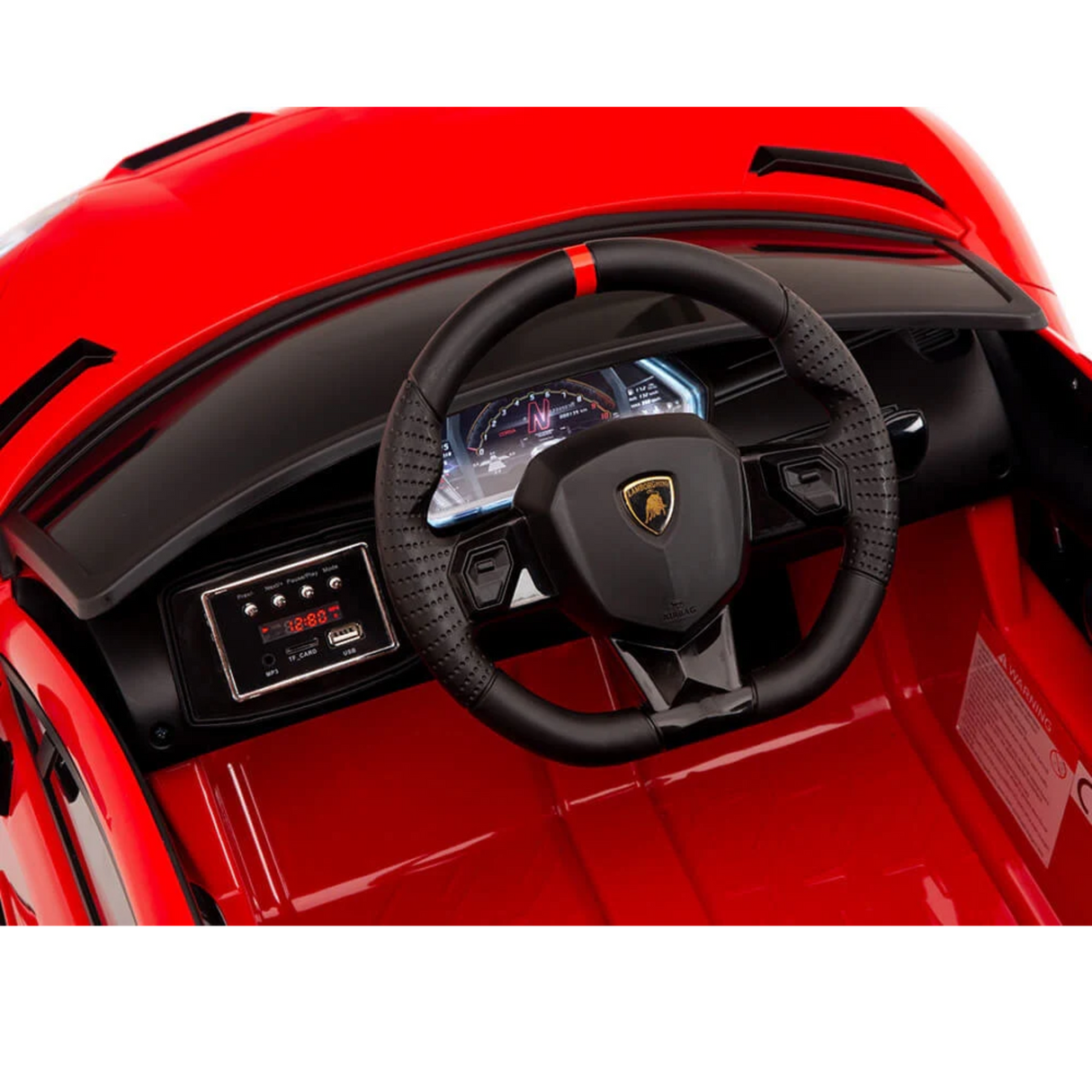 Close-up of the Red 12V Lamborghini SVJ Sport Kids Ride On Cars interior, showcasing a red dashboard with digital displays, a black steering wheel featuring a red stripe and bull-like logo, simulating a real cars feel.