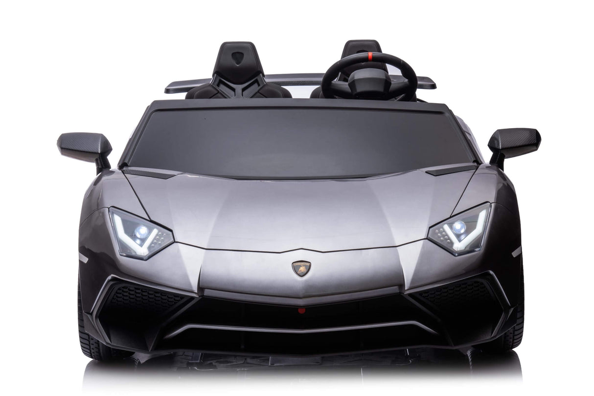 The Grey Giant Official Limited Edition Lamborghini SV 24V/180W ride-on toy sports car, with angular headlights and a detailed front bumper, is shown against a white background. This XXL Edition for big kids, resembling a luxury performance vehicle, features a steering wheel and eco-leather seats.